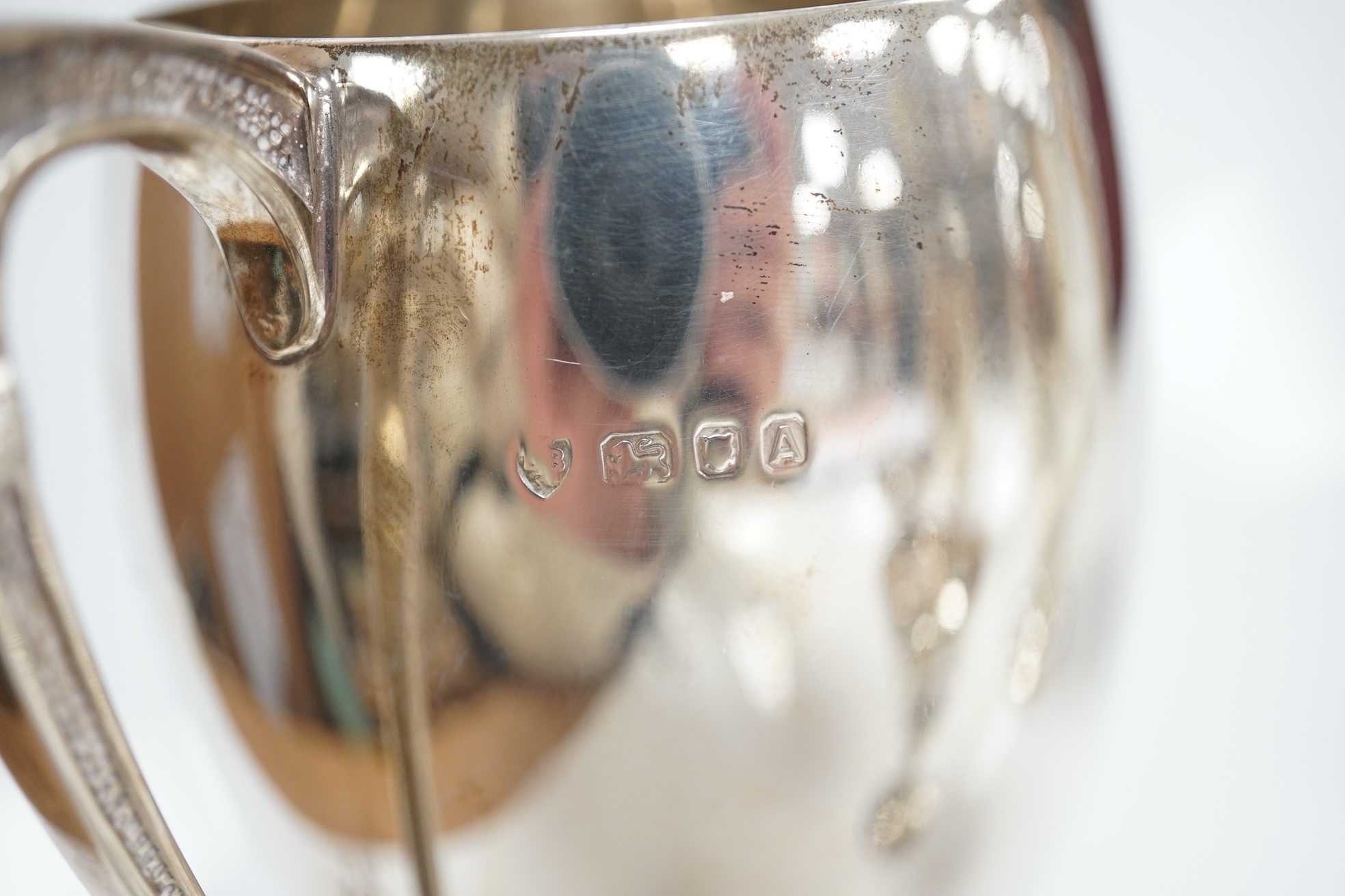 Five assorted small silver trophy cups including a pair by Edward Barnard & Sons, London, 1936, 12.7cm, 20.5cm. Condition poor to fair